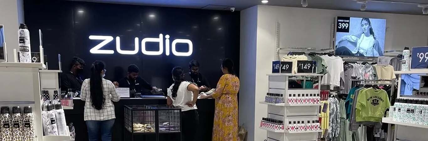Busy clothing store checkout with illuminated brand signage
