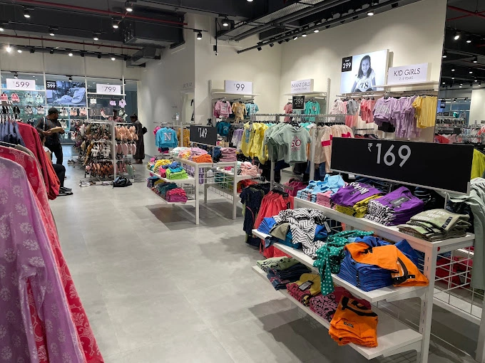 Clothing racks and price displays inside a value fashion store